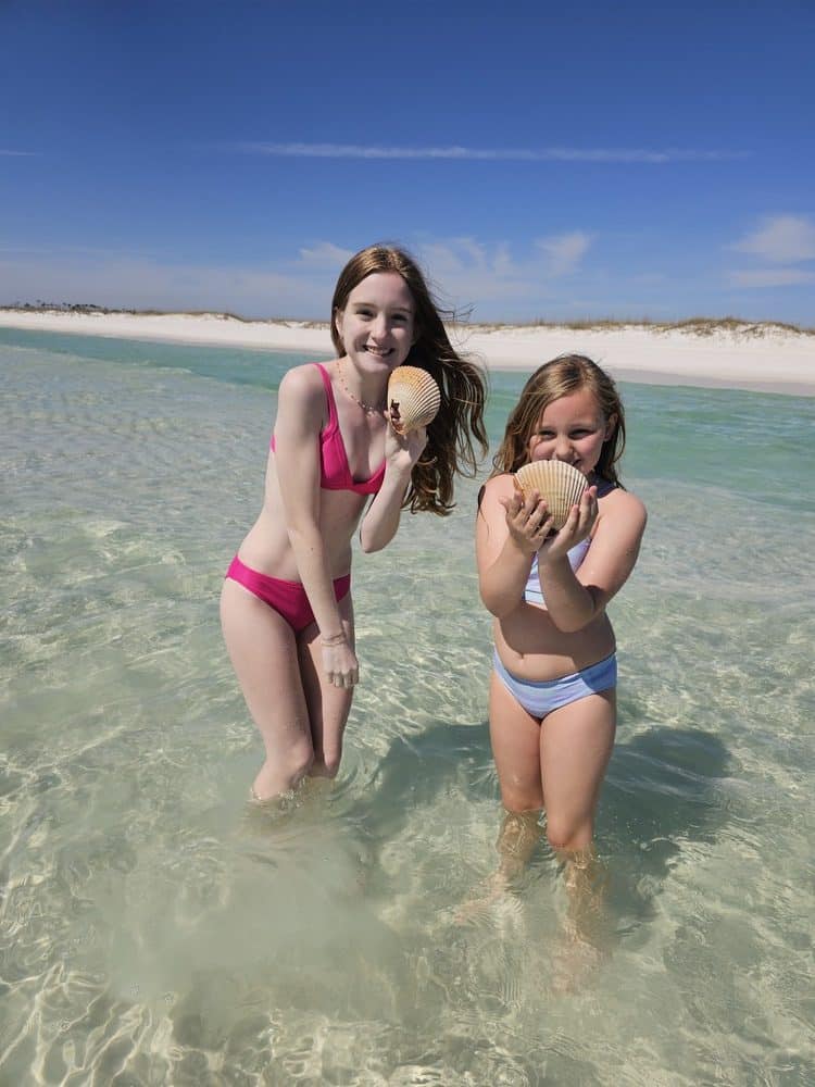 Holding giant cockle clams while shelling on Panama City Beach