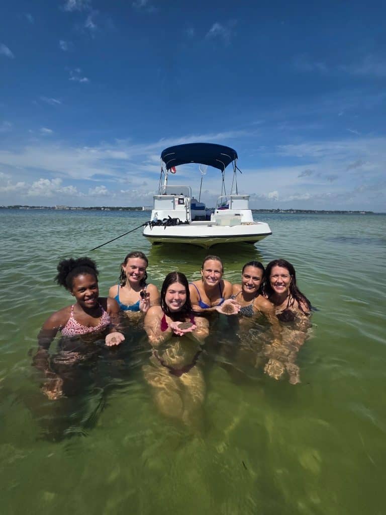 Girls trip snorkeling experience in shallow emerald waters during a bachelorette boat tour in Panama City Beach