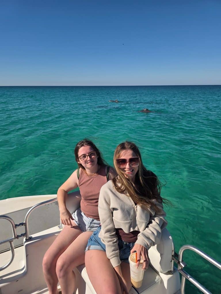 Guests spotting dolphins from a private boat during a Panama City Beach dolphin tour worth it excursion.